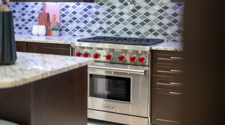 Luxury Wolf stainless steel gas stove and oven unit in custom kitchen installation